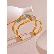 Load image into Gallery viewer, Make a bold statement with our gold-plated stainless steel colorful enamel open angle, designed for fashionable women who love eye-catching accessories. This stylish bangle features an exaggerated, large design adorned with five vibrant enamel circles in red, purple, turquoise, green, and pink, adding a playful splash of color to any outfit. Perfect for making a statement at any occasion, this chic and modern bracelet is a must-have for those who want to stand out with elegance and creativity.