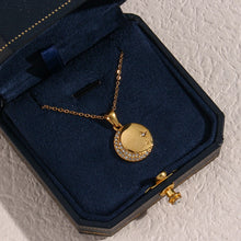 Load image into Gallery viewer, Stainless steel gold plated necklace is made of an elegant and thin chain. There is a round pendant which is adorned with a moon and a star. Both, the moon and the star are made of transparent cubic zirconia. This necklace is a perfect piece for an elegant occasion outfit. It has lobster clasp and adjustable length.