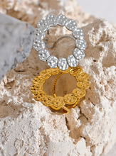 Load image into Gallery viewer, This bold stainless steel ring features a large, open round design crafted from interlocking hammered circles, creating a unique and eye-catching look. Its hollow, hyperbolic shape gives it a personalized, vintage-inspired appeal, perfect for adding a stylish, edgy touch to any outfit. With its trendy, textured metal and artistic detail, this ring is a standout piece for those who love statement jewelry that exudes individuality and modern charm.