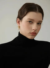 Load image into Gallery viewer, These luxurious drop earrings showcase lustrous natural freshwater pearls paired with delicate stainless steel stars, creating a captivating blend of elegance and whimsy. Crafted with high-quality materials, these earrings offer durability and shine, making them an ideal accessory for fashion-forward individuals who love premium jewelry.