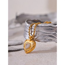 Load image into Gallery viewer, Show your love with this exquisite stainless steel heart love cubic zirconia pendant necklace. Featuring a dazzling heart-shaped cubic zirconia pendant in radiant gold color, this necklace exudes romance and sophistication. Crafted from high-quality stainless steel, it offers lasting shine and durability, making it perfect for everyday wear or special occasions. A timeless piece of jewelry that makes a thoughtful gift or a beautiful addition to your collection.