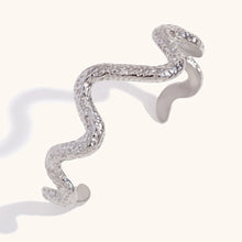 Load image into Gallery viewer, This striking open bangle bracelet features a unique hammered pattern and a sleek snake design, crafted from waterproof stainless steel for durability and style. Its bold, textured look adds an edgy yet elegant touch to any outfit, making it a perfect statement piece for fashion-forward women.