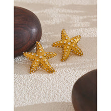Load image into Gallery viewer, These stunning stud earrings, crafted from stainless steel, feature striking starfish pendants that exude summer elegance. Each starfish is beautifully adorned with sparkling cubic zirconia, adding a radiant touch of glamour and sophistication to your look. Perfect for complementing any summer outfit, these earrings effortlessly bring a hint of coastal charm and eye-catching sparkle.