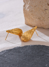 Load image into Gallery viewer, Add a touch of elegance to your look with these fashion stainless steel teardrop stud earrings. Featuring a sleek water drop design and a modern metal texture, these earrings are both trendy and timeless. Made from anti-allergic stainless steel, they offer comfort and durability, perfect for sensitive ears. Whether for everyday wear or a special occasion, these versatile earrings make a stylish addition to any jewelry collection and a thoughtful gift for someone special.