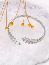 Load image into Gallery viewer, Elevate your style with this fashion stainless steel open charm bracelet. Featuring a stunning golden leaf plant design, this statement piece adds a touch of nature-inspired elegance to any outfit. Durable, waterproof, and crafted for lasting shine, it’s perfect for women who love versatile and eye-catching jewelry. Ideal for daily wear or as a thoughtful gift.