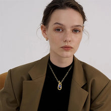 Load image into Gallery viewer, This circle hollow pendant necklace is made out of 18K gold plated stainless steel and it is adorned with cubic zirconia. It is a perfect piece for an elegant occasion outfit. The necklace has a size adjustable chain with a lobster clasp.