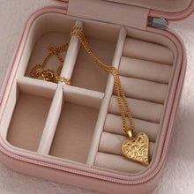 Load image into Gallery viewer, This gorgeous heart pendant necklace is made out of 18K gold plated stainless steel. Heart pedant is adorned with interesting cuts on its surface.The necklace can be perfectly combined with any type of daily or night outfit. It has a size adjustable chain with a lobster clasp.
