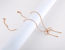 Load image into Gallery viewer, Stainless steel necklace comes in a rose gold colour. It is made of fine thin snake chain which ends with a big bowknot. The necklace is very simple, though makes a perfect accessorize to your outfit. It has lobster clasp.