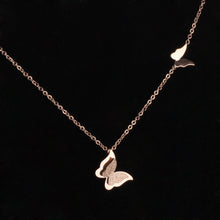 Load image into Gallery viewer, Necklace made of stainless steel comes in two variants: rose gold and silver colour. Necklace is adorned with two beautiful pedants in a shape of a butterfly. The bigger butterfly has one smaller butterfly with sanded surface. The necklace has adjustable length and lobster clasp.