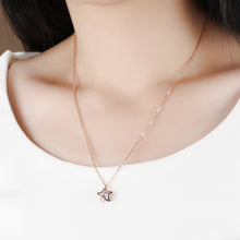 Load image into Gallery viewer, Stainless steel necklace comes in a rose gold and silver colour. It is made of fine thin chain which is adorned with a small pedant in the shape of a star. Star pedant is made of two outlines that surround cubic zirconia in the shape of a circle. The necklace is perfect for daily outfits as well as to light up your night dress. It has lobster clasp