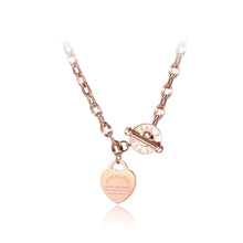 Load image into Gallery viewer, Stainless steel necklace is coming in two colours: rose gold and silver. Big pedant in the shape of a heart is placed at the bottom part. There is a bible proverb engraved on the heart: "Above all else, guard your heart, for everything you do flows from it." Big toggle clasp with engraved letters makes the necklace even more dominant. 