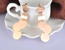 Load image into Gallery viewer, These rock glam stainless steel earrings are made in a rose gold colour. They consists of five connected circles that have shiny surface. Circles are irregularly connected which gives very special look. Earrings are rose gold plated and represent perfect and elegant touch to your day to day style. They have stud fastening.