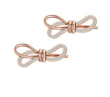 Load image into Gallery viewer, Charming stainless steel earrings are made in a rose gold colour. Earrings are made in a shape of a bow which is adorned with beautiful cubic zirconia. Earrings are rose gold plated and represent elegant and classy accessory for your smart outfit. They have stud fastening.