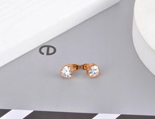 Load image into Gallery viewer, Classy and elegant stainless steel earrings are made in a rose gold and silver colour. The earrings are made in a shape of a heart which is adorned with big cubic zirconia. Earrings are rose gold plated and represent perfect and elegant touch to your classy and smart outfit. They have stud fastening.