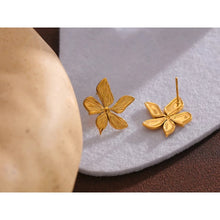 Load image into Gallery viewer, Elegant stainless steel earrings are made in a gold colour. Earrings are made in a shape of a small flower. The surface of the petals is carved which makes them more interesting end effective. Earrings have real gold plating and represent great accessory to your everyday outfit. They have stud fastening.