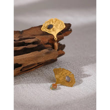Load image into Gallery viewer, Exquisite stainless steel earrings are made in a gold colour. They are made in a shape of a ginkgo leave which is additionally adorned with natural stone. One smaller stone is placed on the leave and can come in red or green colour. Other bigger stone is hanging under the leave and it has turquoise colour. Earrings have real gold plating and represent great accessory to your everyday outfit. They have stud fastening.
