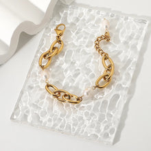 Load image into Gallery viewer, Bracelet is made of stainless steel and comes in a gold colour. This statement bracelet is additionally adorned with freshwater pearls. The length is adjustable with an extra chain that ends with a pearl. This piece of jewelry is perfect accessory for your night out.