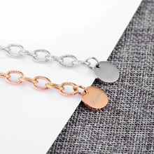 Load image into Gallery viewer, Beautiful stainless steel bracelet comes in two colours: rose gold and silver. It is made of rugged link chain which is adorned with circle charm and word: 'Forever'. The bracelet has adjustable length and lobster clasp. Its simplicity makes it perfect accessories to any outfit.