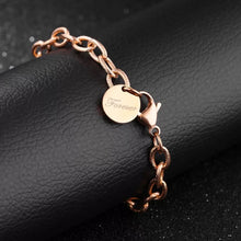 Load image into Gallery viewer, Beautiful stainless steel bracelet comes in two colours: rose gold and silver. It is made of rugged link chain which is adorned with circle charm and word: 'Forever'. The bracelet has adjustable length and lobster clasp. Its simplicity makes it perfect accessories to any outfit.
