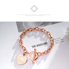 Load image into Gallery viewer, Bracelet is made of stainless steel and comes in three colours: rose gold, gold and silver. It is adorned with a heart pedant with following engraving: 'Above all else guard your heart. For everything you do flows from it'. A big toggle clasp additionally makes it beautiful and statement.