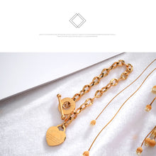 Load image into Gallery viewer, Bracelet is made of stainless steel and comes in three colours: rose gold, gold and silver. It is adorned with a heart pedant with following engraving: 'Above all else guard your heart. For everything you do flows from it'. A big toggle clasp additionally makes it beautiful and statement.