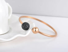 Load image into Gallery viewer, Luxurious bangle bracelet is made of stainless steel and comes in two colours: rose gold and silver. It is richly adorned with two balls. One ball is decorated with cubic zirconia while the other is the same colour as the bangle, rose gold or silver. Cubic zirconia comes in two variants: black and white. This bracelet makes perfect accessory for your evening night out.