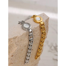 Load image into Gallery viewer, Bracelet is made of stainless steel and has real gold plating. It comes in two colours: gold and silver. It is adorned with a shell plate circled by engraved roman numerals. It has watch clasp and it is a perfect accessory for your smart outfit.