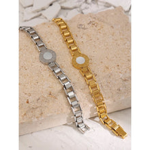 Load image into Gallery viewer, Bracelet is made of stainless steel and has real gold plating. It comes in two colours: gold and silver. It is adorned with a shell plate circled by engraved roman numerals. It has watch clasp and it is a perfect accessory for your smart outfit.