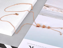 Load image into Gallery viewer, Stainless steel necklace comes in a rose gold colour. It is made of fine thin chain which is adorned with three small pedants in a shape of a butterfly. There are two cubic zirconia attached at the end of each chain as an additional decoration. The necklace is perfect for daily outfits as well as to light up your night dress. It has lobster clasp.