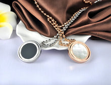 Load image into Gallery viewer, Stainless steel necklace comes in a rose gold and silver colour. It is made of fine beaded chain which is adorned with a statement medallion. Medallion is made of shell and is rotatable. It can be worn on two sides, black and white. The necklace is perfect for daily outfits as well as to light up your night dress. It has lobster clasp.