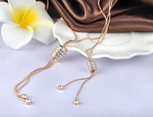 Load image into Gallery viewer, Stainless steel necklace comes in a rose gold colour. It is made of fine thin long chain which is adorned with a beautiful cylinder. Cylinder is additionally decorated with lines of cubic zirconia which makes the necklace perfect accessory for your night out. It has lobster clasp.