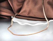 Load image into Gallery viewer, Stainless steel necklace comes in a rose gold, gold and silver colour. It is made of fine thin snake chain. This simple necklace is perfect for daily outfits as well as to light up your night combination. It has adjustable length with lobster clasp. The adjustable chain is adorned with a little pedant in a shape of a heart.
