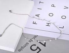 Load image into Gallery viewer, Stainless steel necklace comes in a rose gold and silver colour. it is three times gold plated. The necklace is made of fine thin chain which is adorned with fourteen little pedants in a shape of a star. Star pedants are made in black colour. This elegant bohemian necklace is perfect to spice up any outfit. It has lobster clasp and adjustable chain which is adorned with little pedant in a shape of a heart.