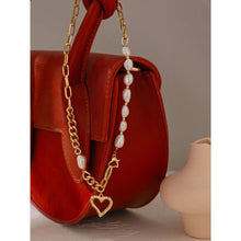 Load image into Gallery viewer, This fashionable necklace comes in a gold colour. It is made of zinc alloy and it is three times gold plated. It is made of big link chain with a combination of pearls. The last link is also a lobster clasp. The necklace is adorned with a hollow heart pedant at its bottom.