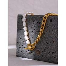 Load image into Gallery viewer, Necklace is made as a combination of stainless steel in gold colour and natural pearls. Half of the necklace is made of thicker link chain that is real gold plated and other half is made of pearls. The necklace is additionally adorned with a bigger toggle clasp at its bottom. Necklace is a real statement piece that will glam up your outfit.