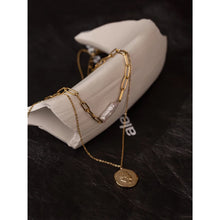 Load image into Gallery viewer, Necklace is made of stainless steel and comes in a gold colour with real gold plating. It is made of two layers. Shorter link chain is adorned with longer irregular pearl, while the thinner, longer and delicate chain is adorned with a medallion. Medallion has a portrait engraved. Necklace has adjustable length and lobster clasp. It is a real nice accessory for any kind of elegant outfit.