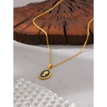 Load image into Gallery viewer, Necklace is made of stainless steel and comes in a gold colour with real gold plating. It is made of a thin and elegant chain which is adorned with a portrait pedant. Pedant is circled with interesting stainless steel border, portrait is in gold colour but the background comes in black colour. Necklace is a very elegant piece that will glam up your outfit. It has adjustable length and lobster clasp.