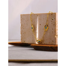 Load image into Gallery viewer, Necklace is made of stainless steel and comes in a gold colour with real gold plating. It is made of a big link chain which is adorned with three eyes with blue rocks in the middle.This very interesting necklace is a real statement piece that will glam up your outfit. It has adjustable length and lobster clasp.