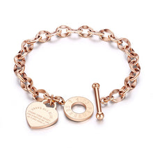 Load image into Gallery viewer, Bracelet is made of stainless steel and comes in three colours: rose gold, gold and silver. It is adorned with a heart pedant with following engraving: 'Above all else guard your heart. For everything you do flows from it'. A big toggle clasp additionally makes it beautiful and statement.