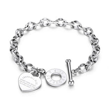 Load image into Gallery viewer, Bracelet is made of stainless steel and comes in three colours: rose gold, gold and silver. It is adorned with a heart pedant with following engraving: 'Above all else guard your heart. For everything you do flows from it'. A big toggle clasp additionally makes it beautiful and statement.