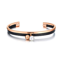 Load image into Gallery viewer, Bangle bracelet is made of stainless steel and comes in rose gold variant. It is adorned with black leather strip and two small balls. One of the balls is in rose gold colour and the other is pearl white. It is perfect accessory for going out.