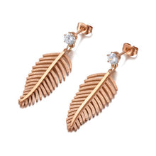Load image into Gallery viewer, Elegant stainless steel earrings are made in a rose gold colour. They consists of small cubic zirconia on which a leave of fern is hanging. The surface of the fern is sanded which gives the earrings special look. Earrings are rose gold plated and represent great accessory to your elegant outfit. They have stud fastening.