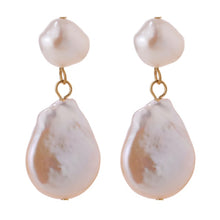 Load image into Gallery viewer, Elegant and luxury earrings are made in a gold colour. They consists of two irregular natural pearls that are hanging one above the other. Lower pearl is bigger than the upper one. Earrings have real gold plating and represent great accessory to your elegant outfit. They have stud fastening.