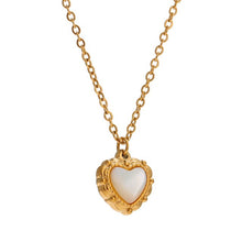 Load image into Gallery viewer, Necklace is made of stainless steel and comes in a gold colour with real gold plating. It is made of a thin elegant chain that is adorned with a heart pedant. Heart pedant is made of shell and it is circled with stainless steel border with interesting engravings. Necklace is a very elegant piece that will glam up your outfit. It has adjustable length and lobster clasp.