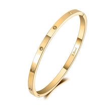 Load image into Gallery viewer, Elegant bangle bracelet is made of stainless steel and comes in four colours: rose gold, gold, black and silver. It is adorned around its perimeter with sparkling cubic zirconia crystals. It is perfect accessory for evening occasions and will sparkle your every outfit.