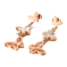Load image into Gallery viewer, Elegant stainless steel earrings are made in a rose gold and silver colour. They consists of three connected butterflies. Butterflies are connected from the smallest one to the biggest. The smallest one has shiny rose gold surface, the middle one is adorned with white shell and the biggest one represents only butterfly silhouette. Earrings are rose gold plated and represent perfect and elegant touch to your evening outfit. They have stud fastening.
