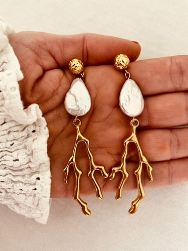 Elevate your summer style with these stunning handmade statement earrings, featuring a bold combination of a lustrous natural freshwater pearl and a striking coral drop. Crafted from gold-plated stainless steel for durability and shine, these lightweight yet eye-catching earrings blend elegance with a touch of coastal charm—perfect for any occasion.