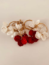 Load image into Gallery viewer, Add a touch of delicate elegance to your look with these minimalistic stud earrings. Featuring thin stainless steel circles adorned with shell flower petals, they offer a perfect blend of modern simplicity and natural beauty. Lightweight and versatile, these earrings are ideal for everyday wear or special occasions, effortlessly complementing any outfit with their subtle charm.
