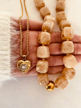 Load image into Gallery viewer, Show your love with this exquisite stainless steel heart love cubic zirconia pendant necklace. Featuring a dazzling heart-shaped cubic zirconia pendant in radiant gold color, this necklace exudes romance and sophistication. Crafted from high-quality stainless steel, it offers lasting shine and durability, making it perfect for everyday wear or special occasions. A timeless piece of jewelry that makes a thoughtful gift or a beautiful addition to your collection.
