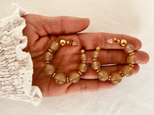 Load image into Gallery viewer, Add a touch of modern elegance to your look with these resin round beads chain C-Shape huggie earrings. Handmade with care, they feature glossy resin round beads paired with a sleek stainless steel chain for a lightweight yet durable finish. Inspired by trendy French fashion, these C-shape huggie earrings offer a stylish balance of chic and contemporary design, making them perfect for everyday wear or special occasions. A must-have statement accessory for women who love unique, fashionable jewelry.
